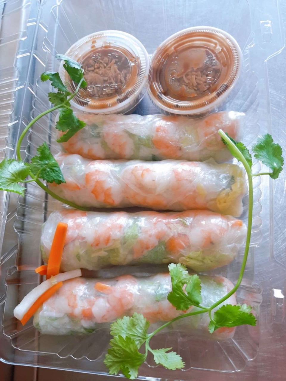 Shrimp salad rolls with dipping sauce.