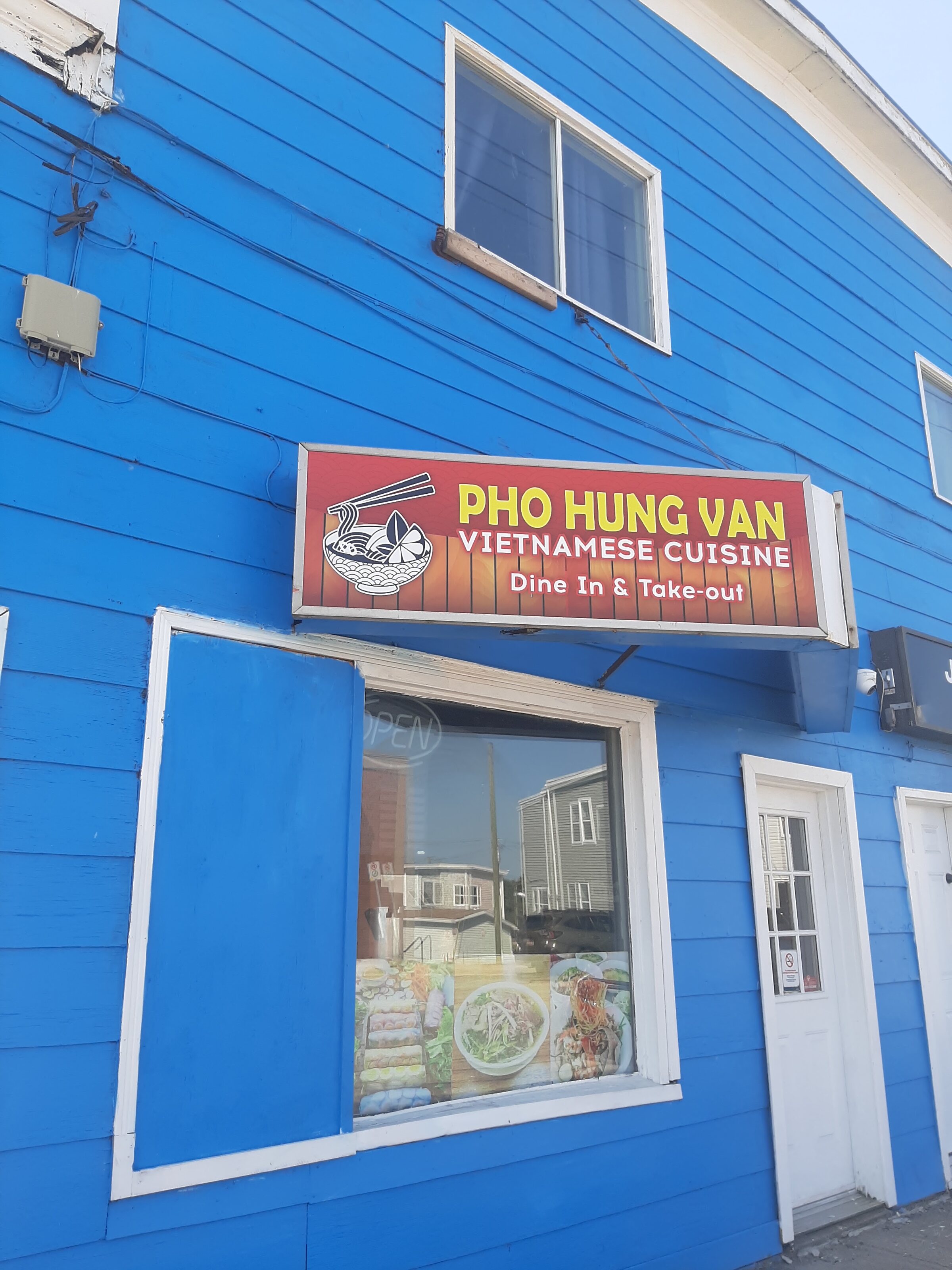 The bright blue Pho Hung Van storefront in Saint John, with its red and yellow Vietnamese Cuisine sign above the window.